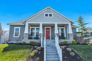 Craftsman house featuring covered porch and a front lawn