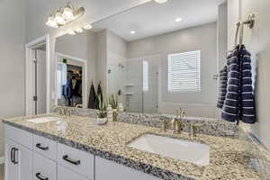 Bathroom with dual vanity and a shower with door