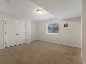 Unfurnished bedroom featuring a closet and carpet