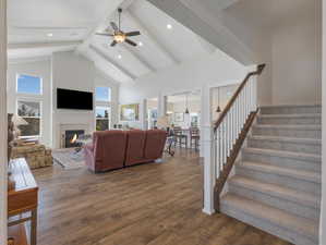 Living room with dark hardwood / wood-style flooring, a healthy amount of sunlight, and beam ceiling