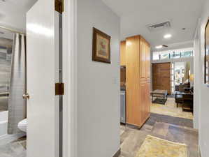 Hall featuring light tile patterned floors