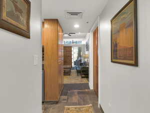 Corridor with dark tile patterned flooring