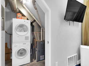 Laundry area featuring stacked washer / drying machine