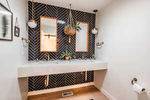 Powder Room featuring double sinks