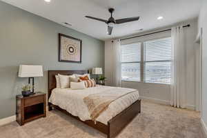 Bedroom with light carpet and ceiling fan