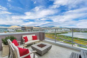 View of patio / terrace with a mountain view, a balcony, and an outdoor fire pit