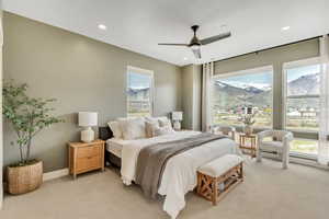 Bedroom with a mountain view, carpet flooring, and ceiling fan