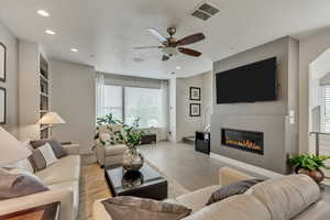 Tiled living room featuring ceiling fan