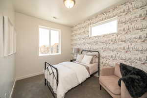 Bedroom with dark colored carpet