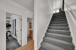 Stairs featuring hardwood / wood-style floors