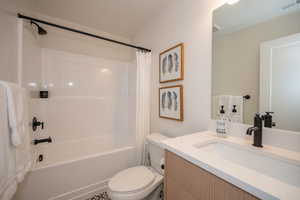 Full bathroom featuring vanity, toilet, and shower / bath combo with shower curtain