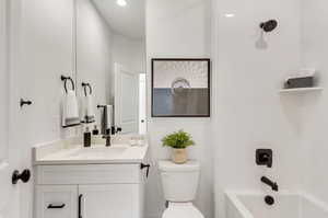 Full bathroom featuring shower / bathtub combination, vanity, and toilet