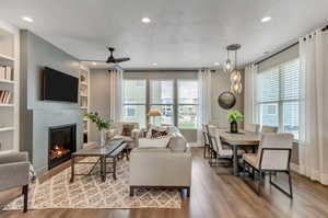 Living room featuring built in shelves and light hardwood / wood-style floors