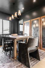 Dining space with an inviting chandelier and hardwood / wood-style flooring