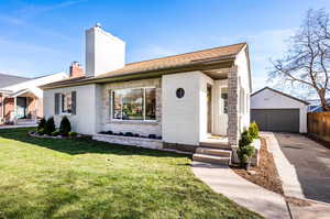 Single story home with an outbuilding, a garage, and a front yard