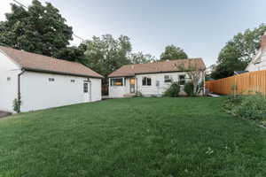 Back of property featuring a lawn