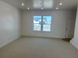 Spare room with carpet flooring and a textured ceiling