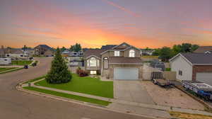 Front of property with a garage and a yard