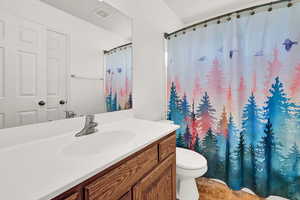 Bathroom with vanity, tile patterned flooring, and toilet