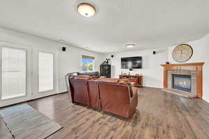 Living room featuring a textured ceiling and hardwood / wood-style flooring