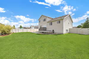 Rear view of property featuring a lawn