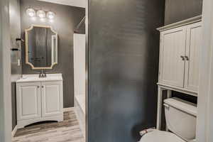 Primary Suite Bathroom with Updated Floor, Black Faucet, Mirror, Lighting, Vanity & Accessories