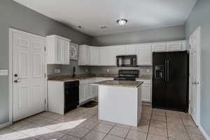 Kitchen with Beautiful Granite Countertops & Island with Plug