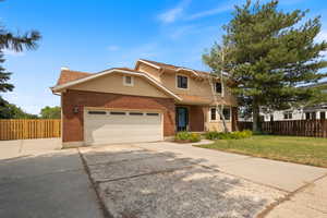 Front of property with RV parking,  garage and a front lawn