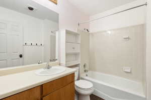 Full bathroom with vanity, toilet, tiled shower / bath, and tile  flooring