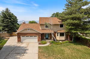 View of property with a front yard