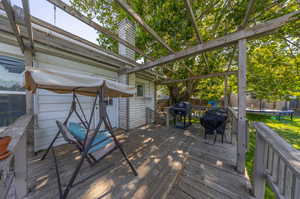 Wooden terrace with a trampoline and grilling area