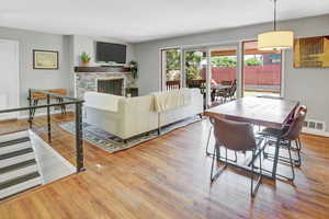 Living room featuring light hardwood / wood-style flooring and a fireplace