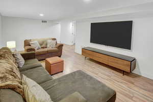 Living room with light hardwood / wood-style floors