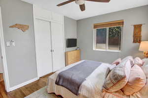 Bedroom featuring a closet, ceiling fan, and hardwood / wood-style floors