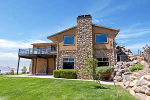 Exterior space featuring a balcony and a lawn