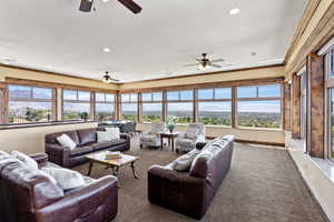 Living room with carpet floors and ceiling fan