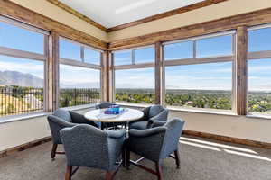 Dining room featuring a mountain view, carpet, and a wealth of natural light