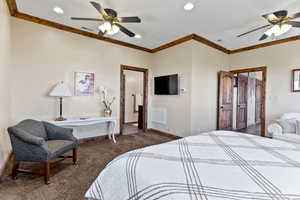 Bedroom with crown molding, ceiling fan, and carpet flooring