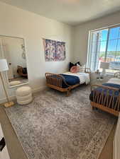 Bedroom featuring a textured ceiling and carpet floors