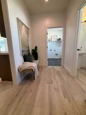 Hallway with light hardwood / wood-style floors