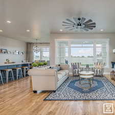 Living room featuring ceiling fan and hardwood / wood-style floors