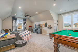 Game room featuring pool table, light colored carpet, a wealth of natural light, and ceiling fan