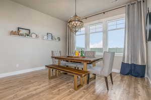 Dining area with a chandelier and light hardwood / wood-style floors