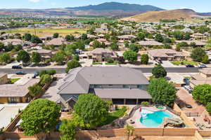 Birds eye view of property with a mountain view and pool.