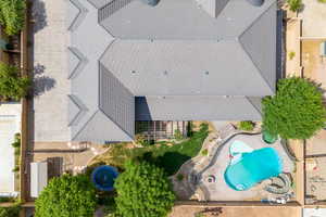 Drone / aerial view og in the gound trampoline, chicken coop, and pool