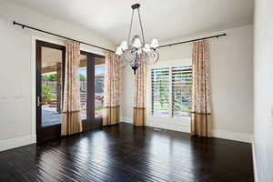 Dining room with hardwood / wood-style flooring and a notable chandelier