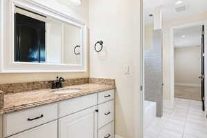 Jack and jill Bathroom with vanity and tile patterned flooring