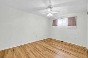 Unfurnished room featuring ceiling fan and light hardwood / wood-style floors