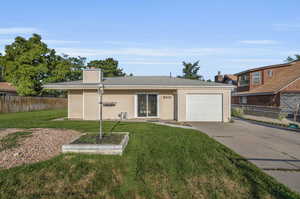 Ranch-style house with a garage and a front yard