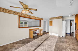 Tiled home office featuring ceiling fan and rail lighting